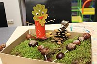 crafted figures made from autumn leaves and chestnuts on moss