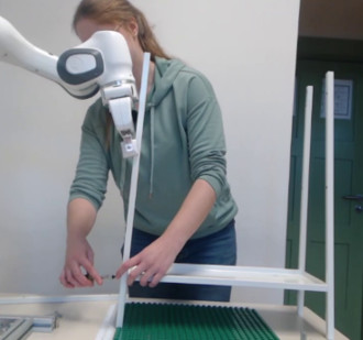 Image of human building together with a robot shelf.