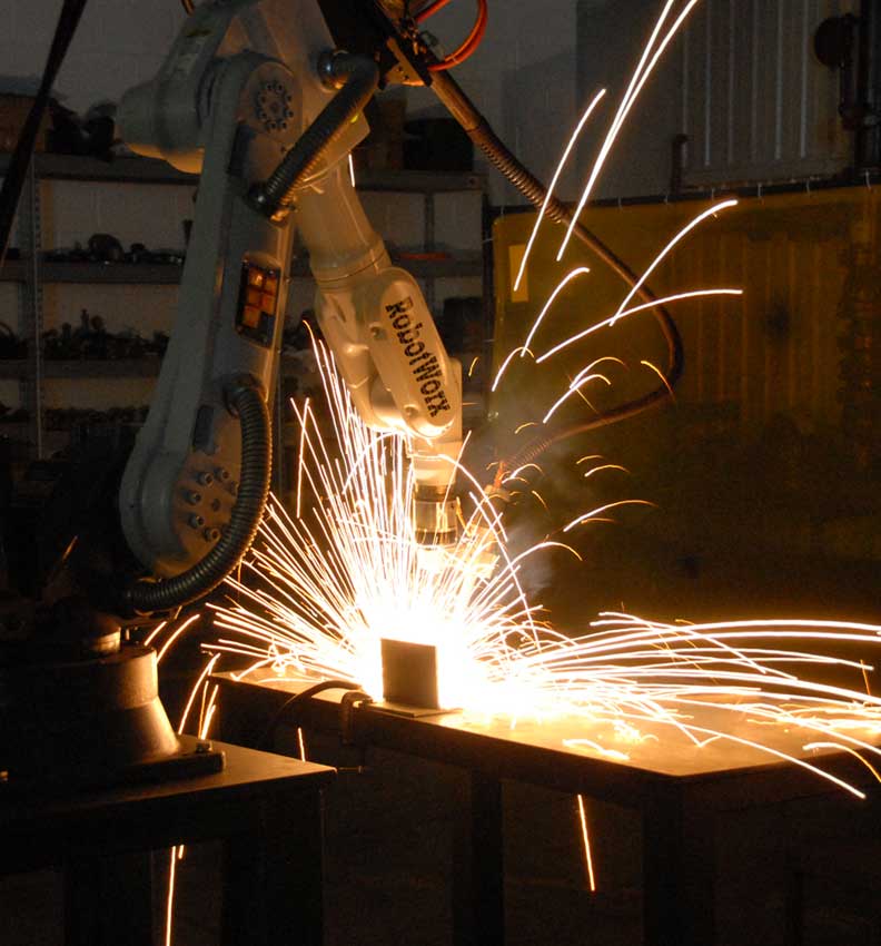 Image showing an industrial robot while welding.