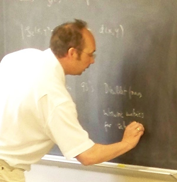 Photo shows professor Stollmann writing something on the board