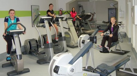 Im Zentrum für Fitness und Gesundheit trainieren Studierende an verschiedenen Geräten.