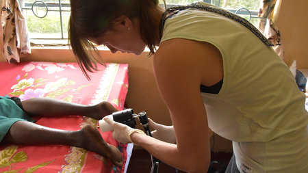 Tina Drechsel studies the foot sole sensitivity of a study participant in Kenya
