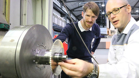Dr. Andreas Otto and Dr. Martin Kolouch are working on a machine