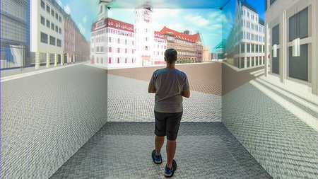 A test subject stands in front of a simulation of the Chemnitz Market Square in the VR studio.
