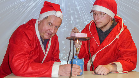 Zwei Männer hantieren mit einem Brenner.