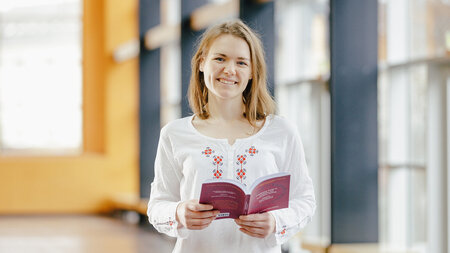 Frau hält Buch in der Hand