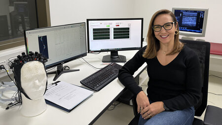A woman is sitting at a computer.