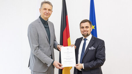 Two man with  letter of appointment