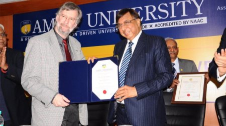 Two men holding the certificate “Honorary Professor”.
