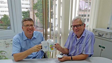 Two men toasting with cups