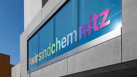The Weinhold-Bau of TU Chemntiz with a pictured window that says: #wirsindchemnitz