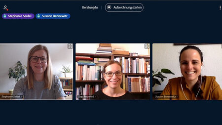 Screenshot of a video conference showing three women sitting in front of book cases.