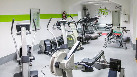  Photo of a fitness studio with different exercise machines.