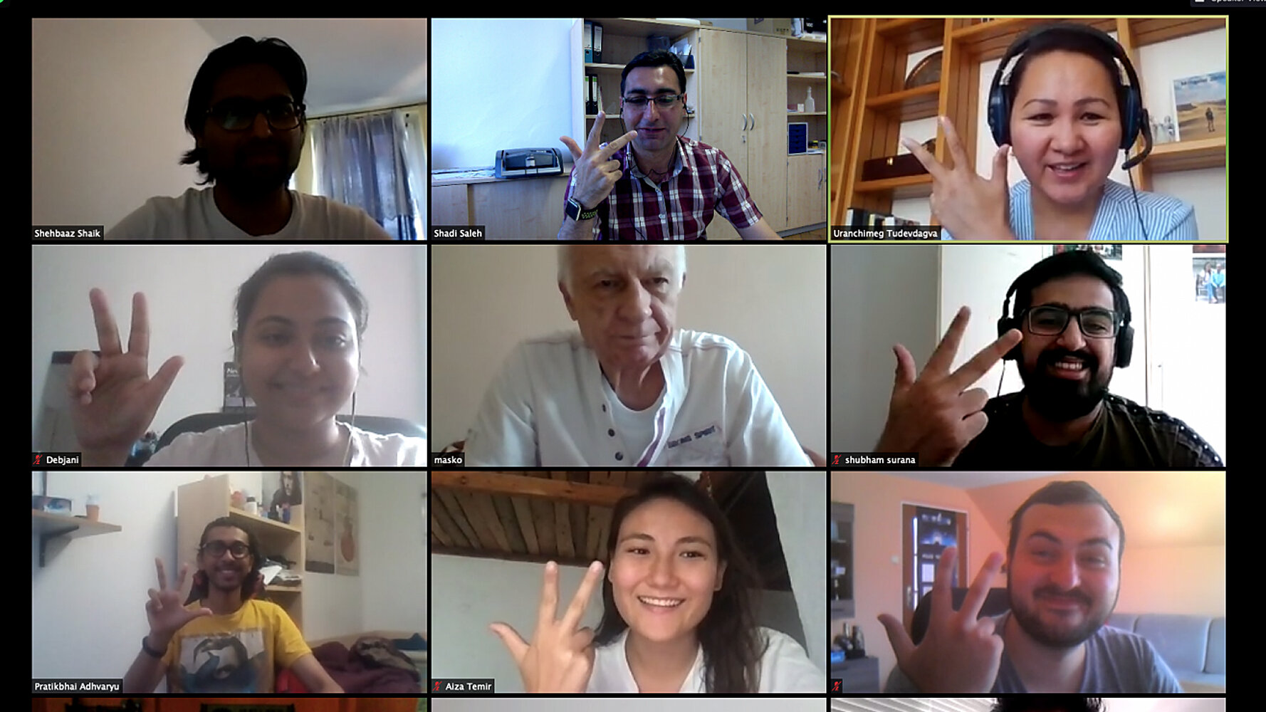 Screenshot from a video conference showing nine men and women