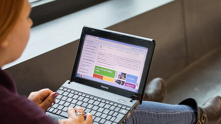 Photo of a woman using a chromebook.