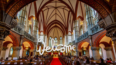 View into the St. Peter's Church in Chemnitz with the highlighted text welcome.