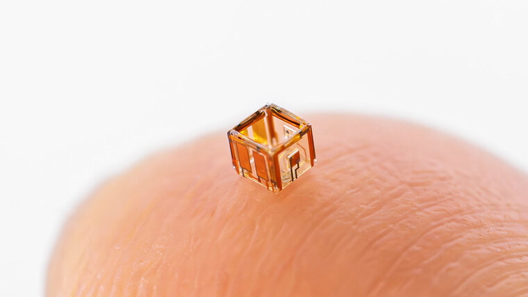 microrobot sitting on a fingertip