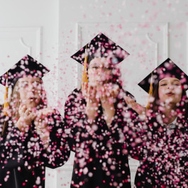 Three female graduates with gown and hats thwrowing confetti towards the camera.