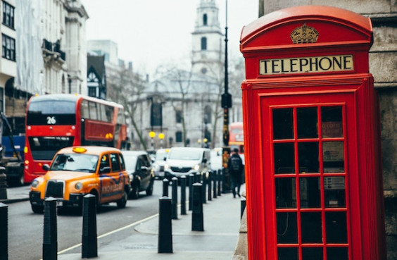 Eine rote Telefonzelle, ein gelbes Taxi und ein roter Doppeldeckerbus in den Strassen Londons