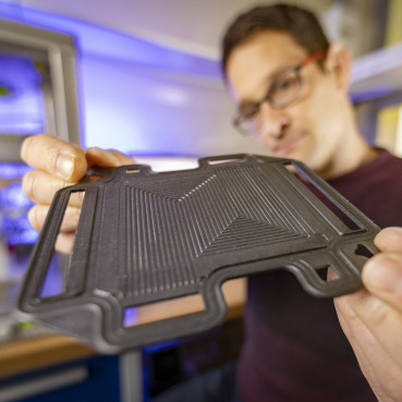 Person holding a graphite plate