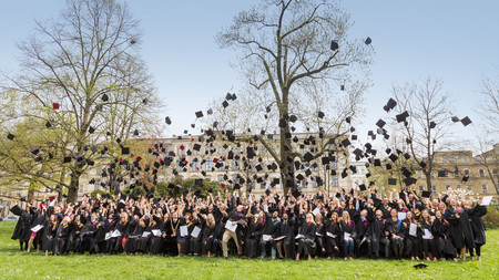 Photo of the 500 round graduates throwing their hats