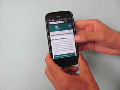 Photo of a smartphone with the TU mobile site